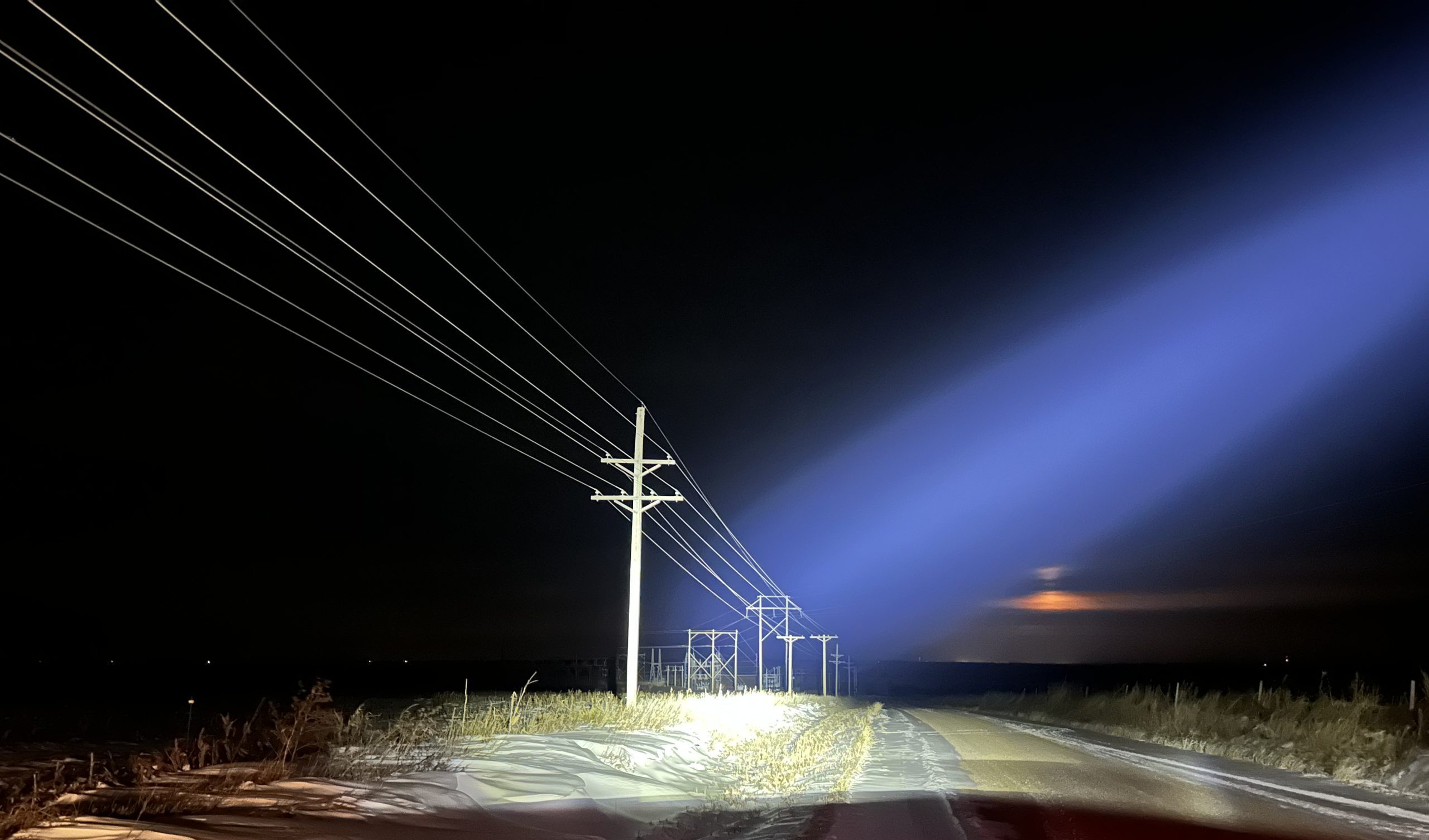 LED Hybrid light shining on light pole at night